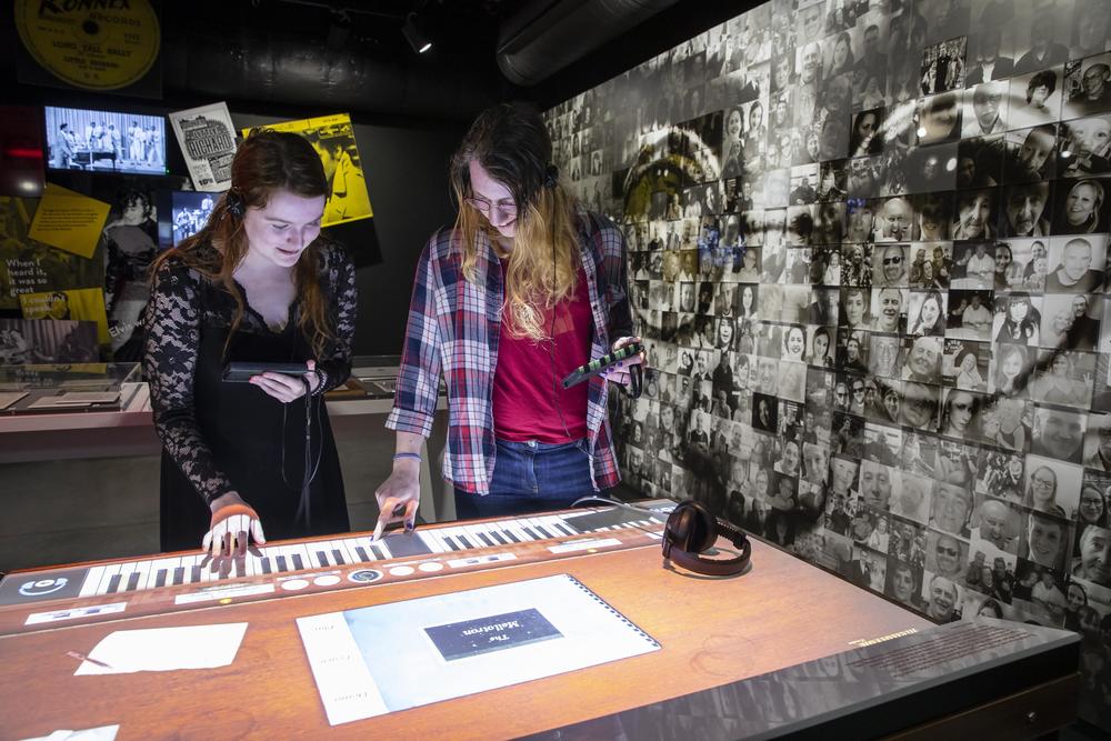Two girls playing the virtual Mellotron in the interactive exhibition