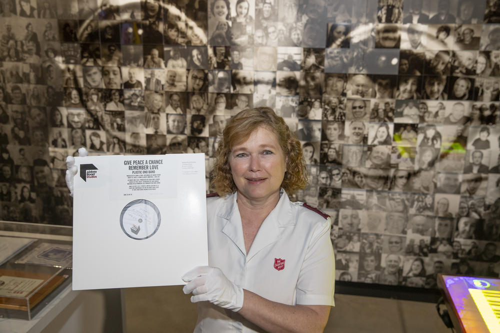 Major Kathy Versfeld holding the Give Peace a Chance vinyl