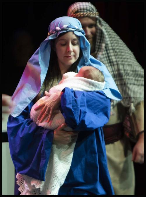 Mary holds baby and Joseph in nativity scene 